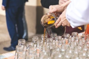 Food caterer pouring drinks at a wedding