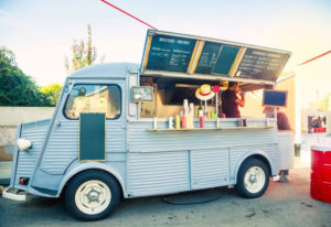 Light blue food truck serving guests at event